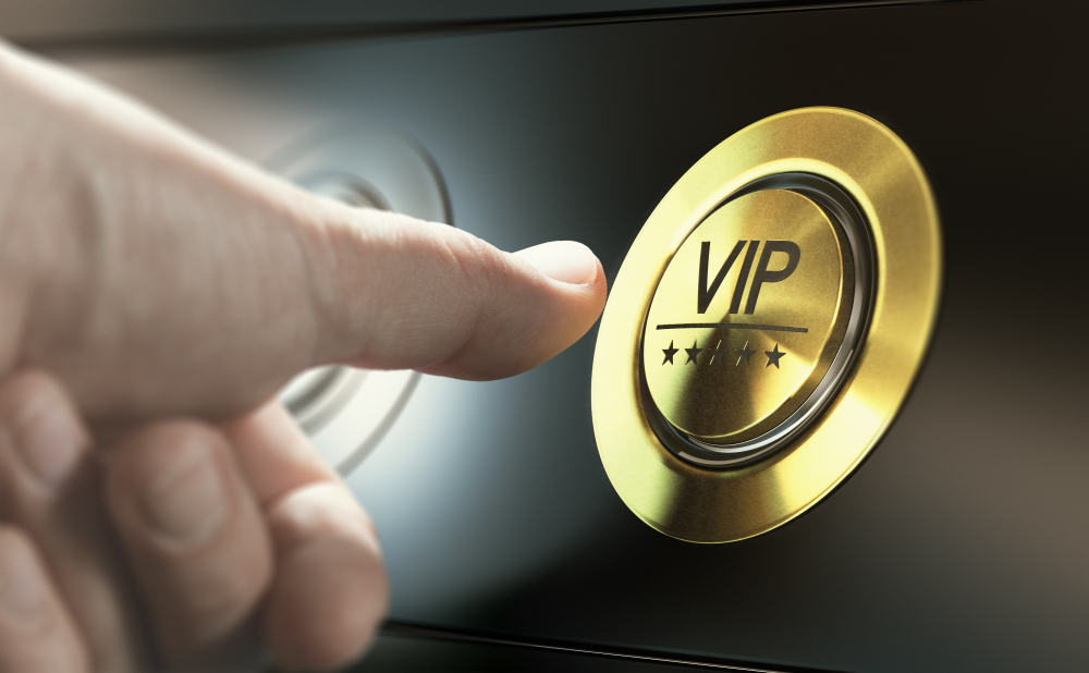 thumb presses gold VIP button