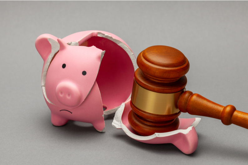 Gavel breaking a piggy bank